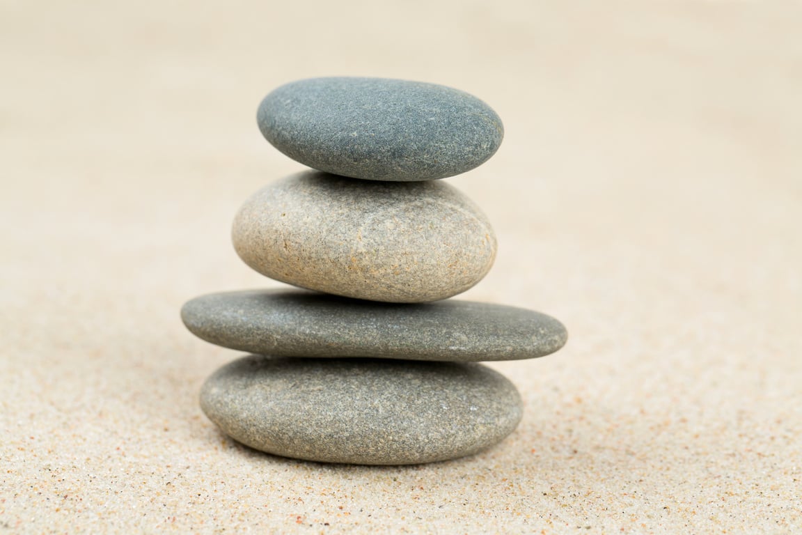 stone pyramid on sea sand